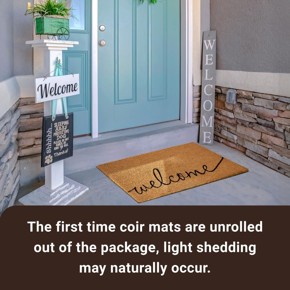 Rectangular coco coir door mat with rubber backing in neutral tone, shown at entryway entrance — view 3