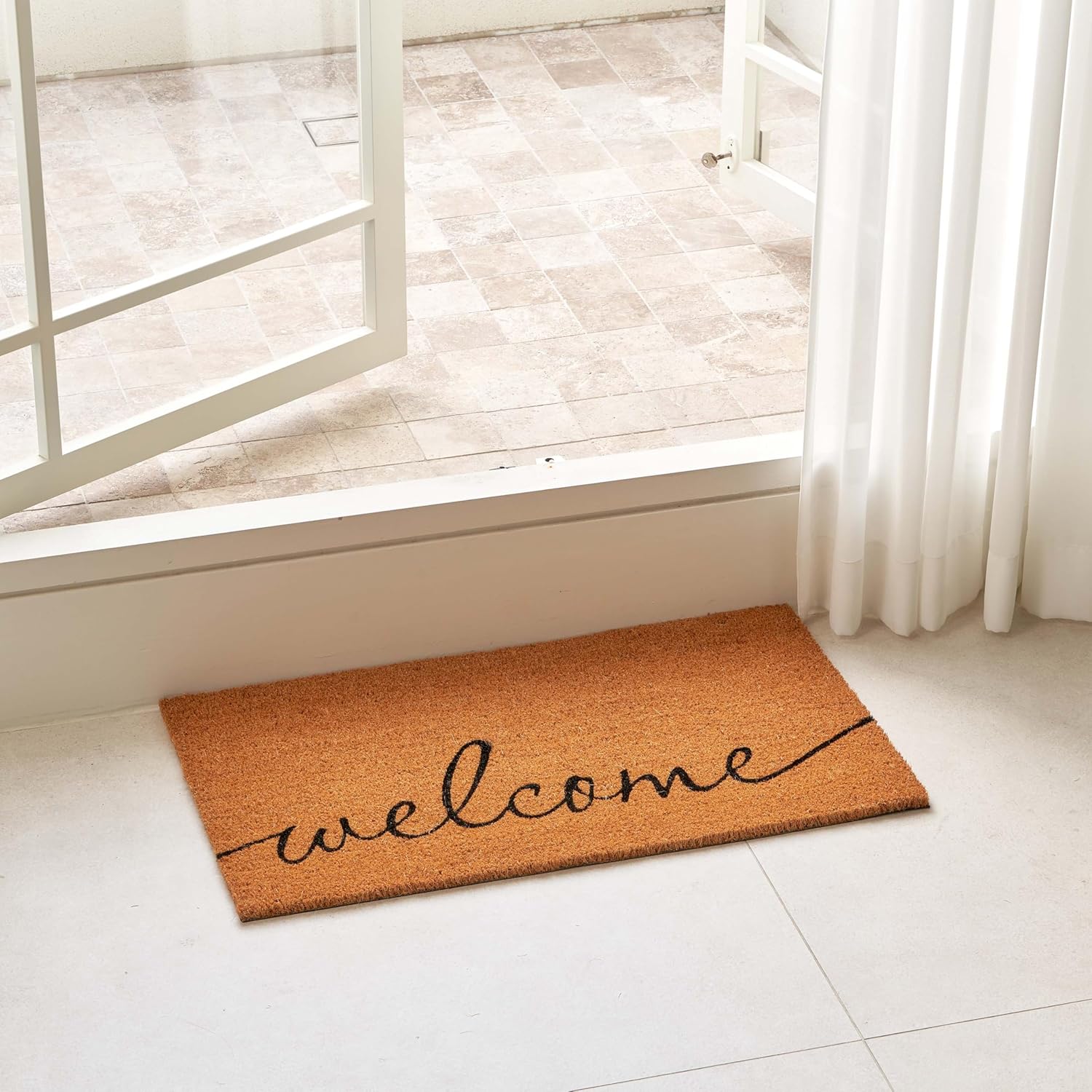 Rectangular coco coir door mat with rubber backing in neutral tone, shown at entryway entrance — view 5