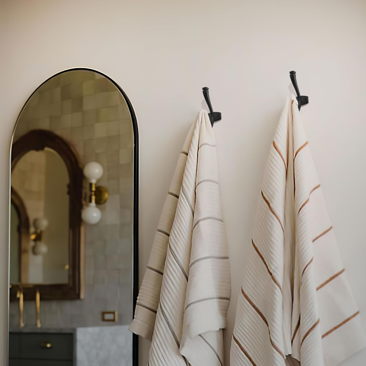 Matte black metal double wall hook with minimalist design, shown mounted on white wall — view 2