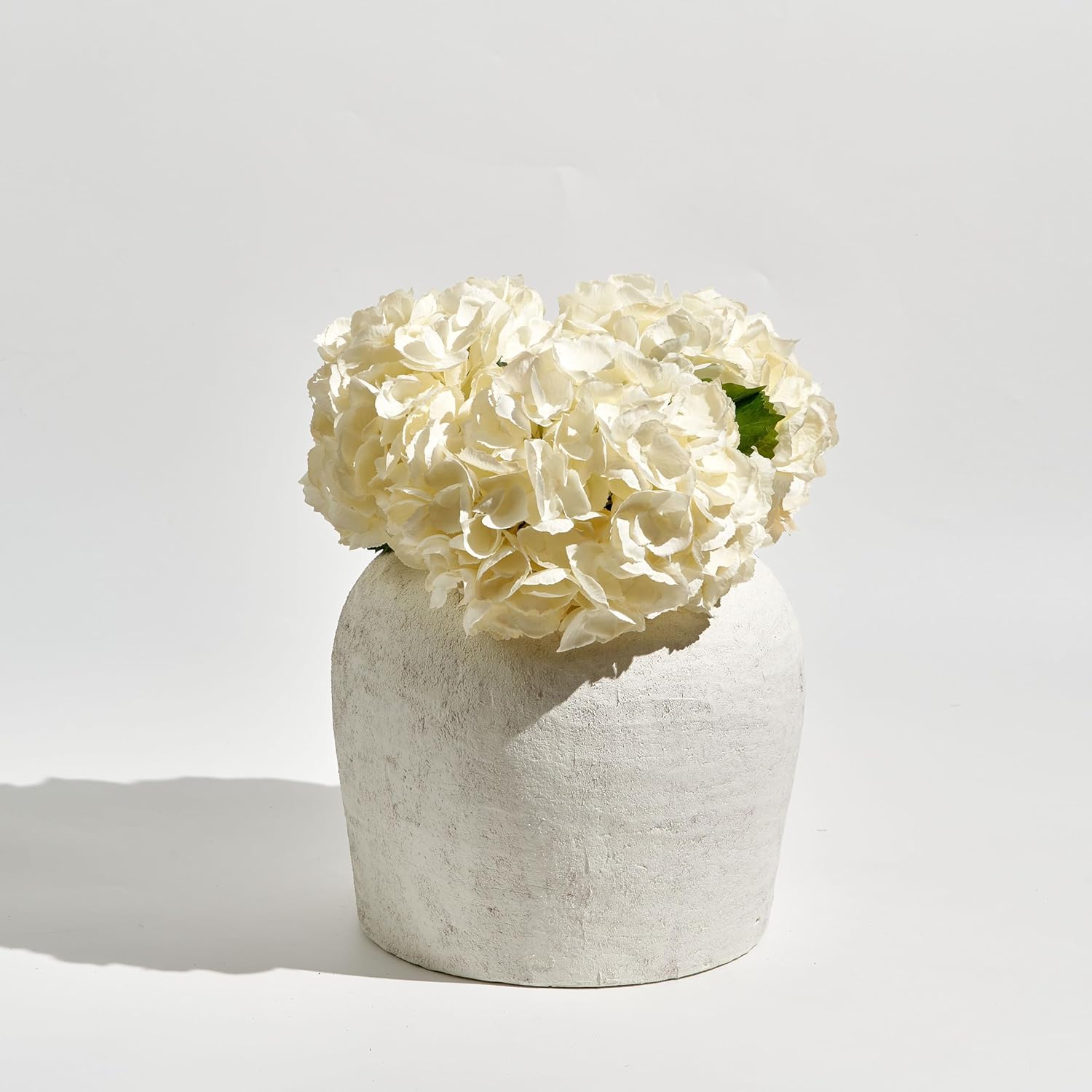 11-inch white ceramic vase with distressed farmhouse finish, shown in {color} against {background} — view 6