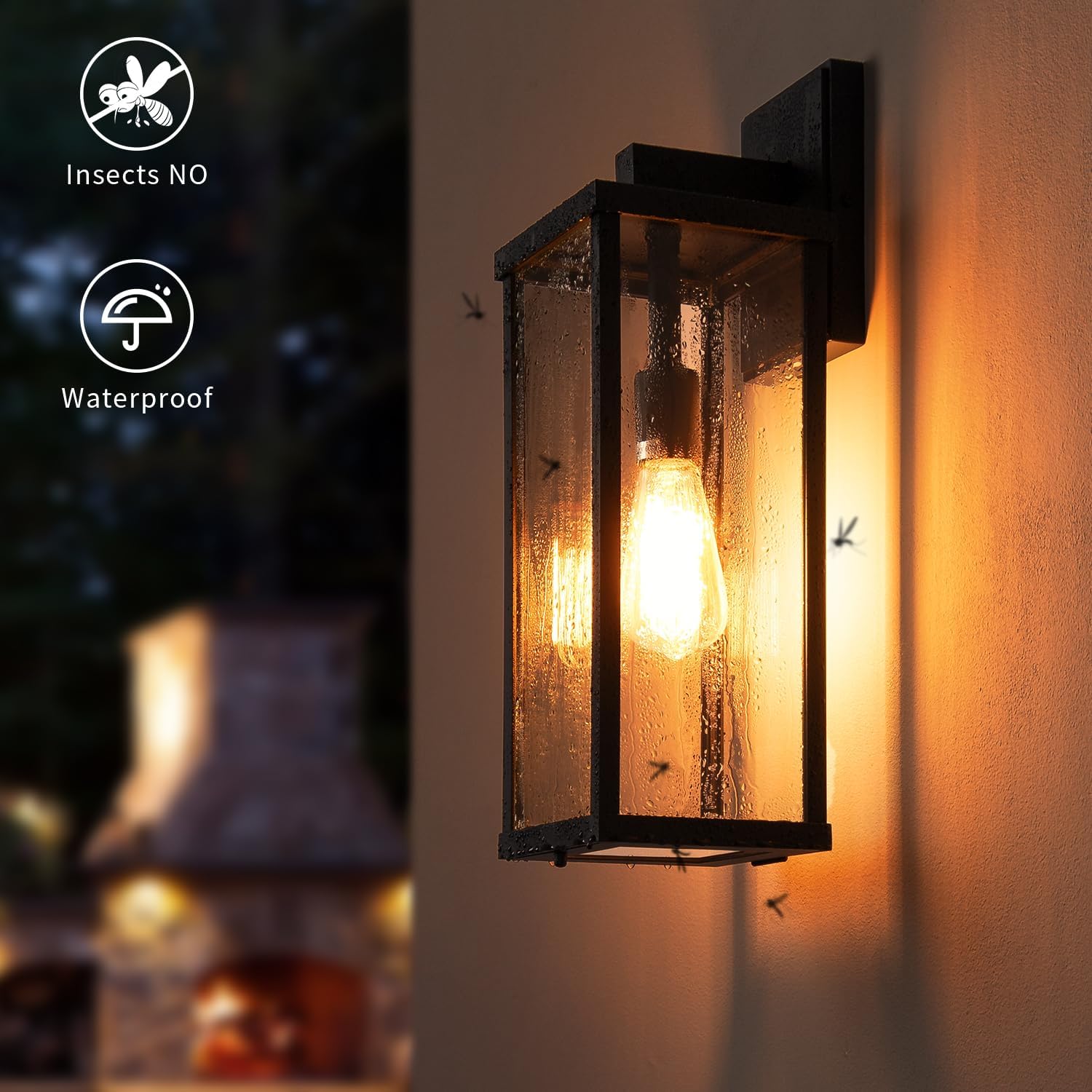 Matte black metal rectangular outdoor wall sconce with clear glass shade, shown mounted on porch exterior — back