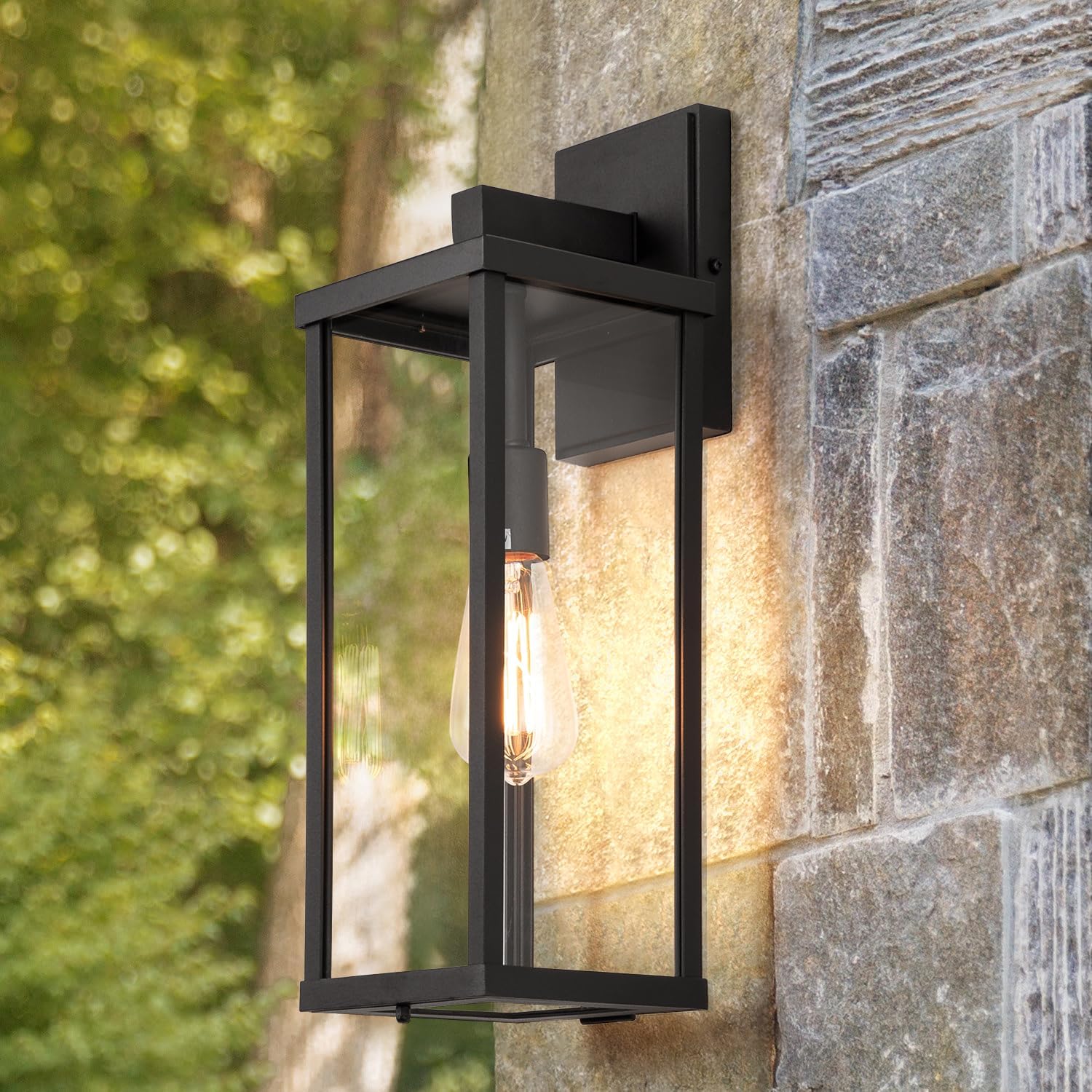 Matte black metal rectangular outdoor wall sconce with clear glass shade, shown mounted on porch exterior — detail