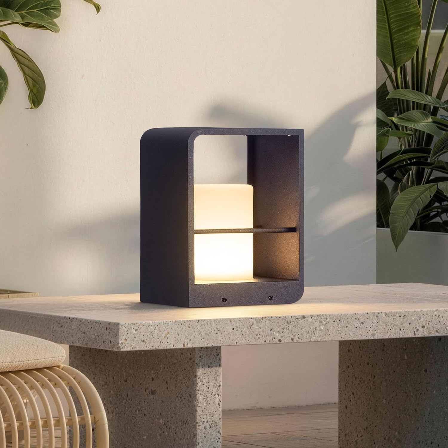 Modern minimalist solar table lamp in neutral plastic with LED bulb and solar panel, displayed on outdoor patio table — front