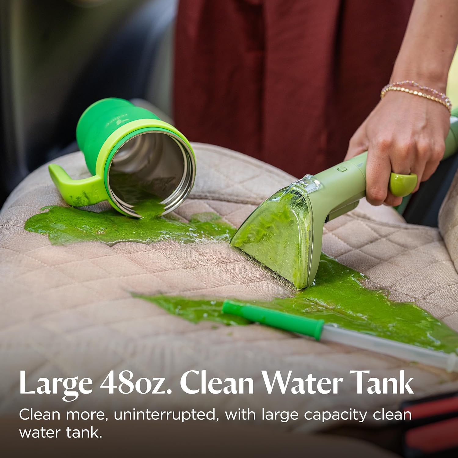 Black portable carpet cleaning machine with plastic housing and metal components, shown from front angle on light background — view 7