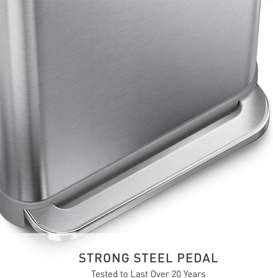 Rectangular brushed stainless steel step trash can with grey plastic lid and pedal mechanism, shown in modern kitchen setting — view 3