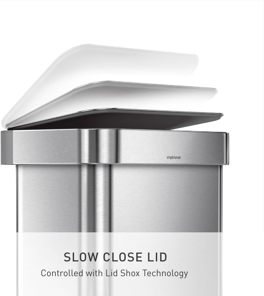 Rectangular brushed stainless steel step trash can with grey plastic lid and pedal mechanism, shown in modern kitchen setting — view 4
